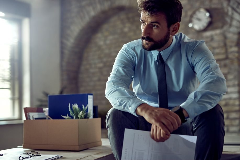 A distraught, well-dressed male holding a peace bond in BC in an office environment